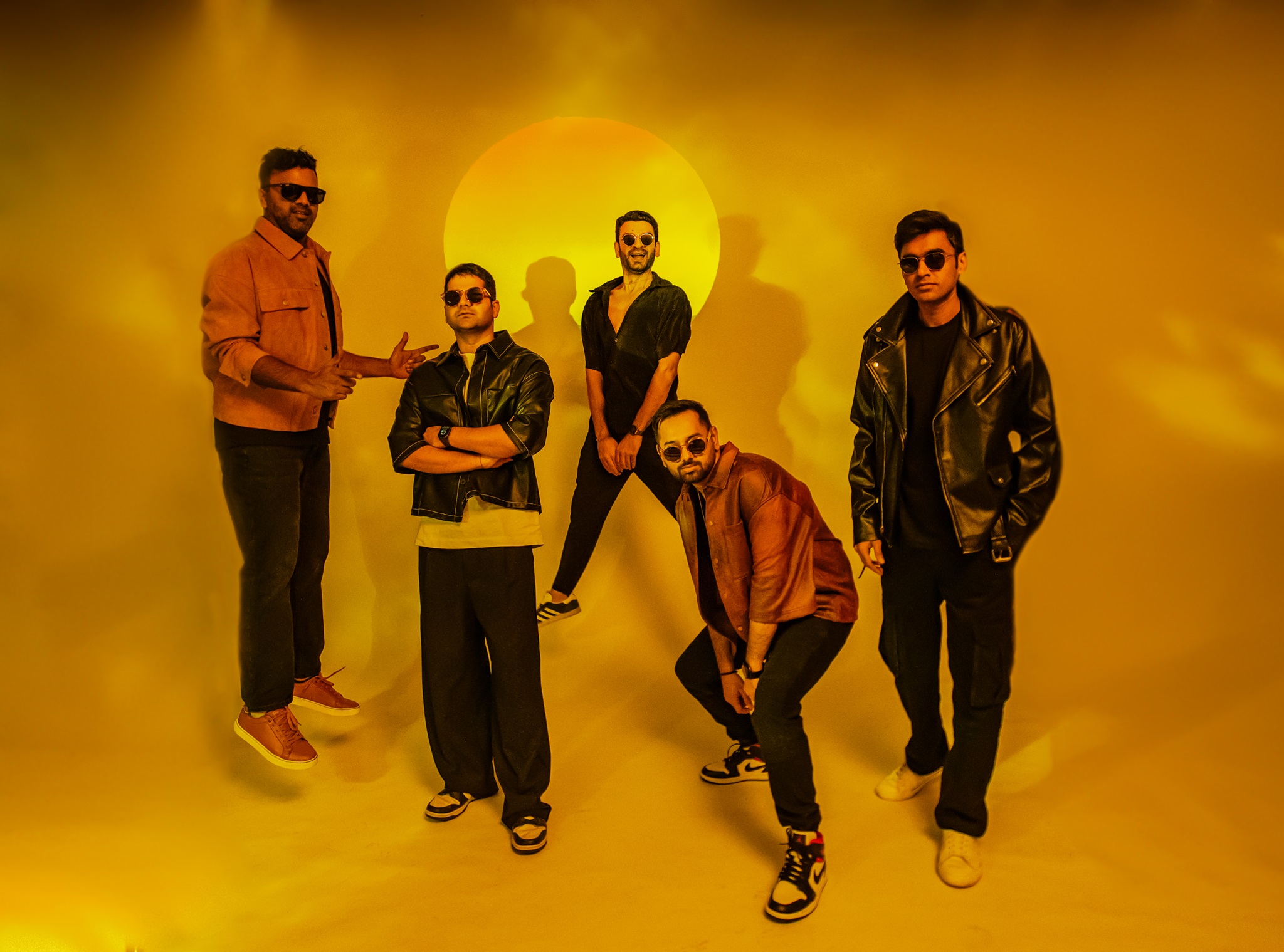 The Yellow Diary band members in jackets and sunglasses posing with yellow tint background