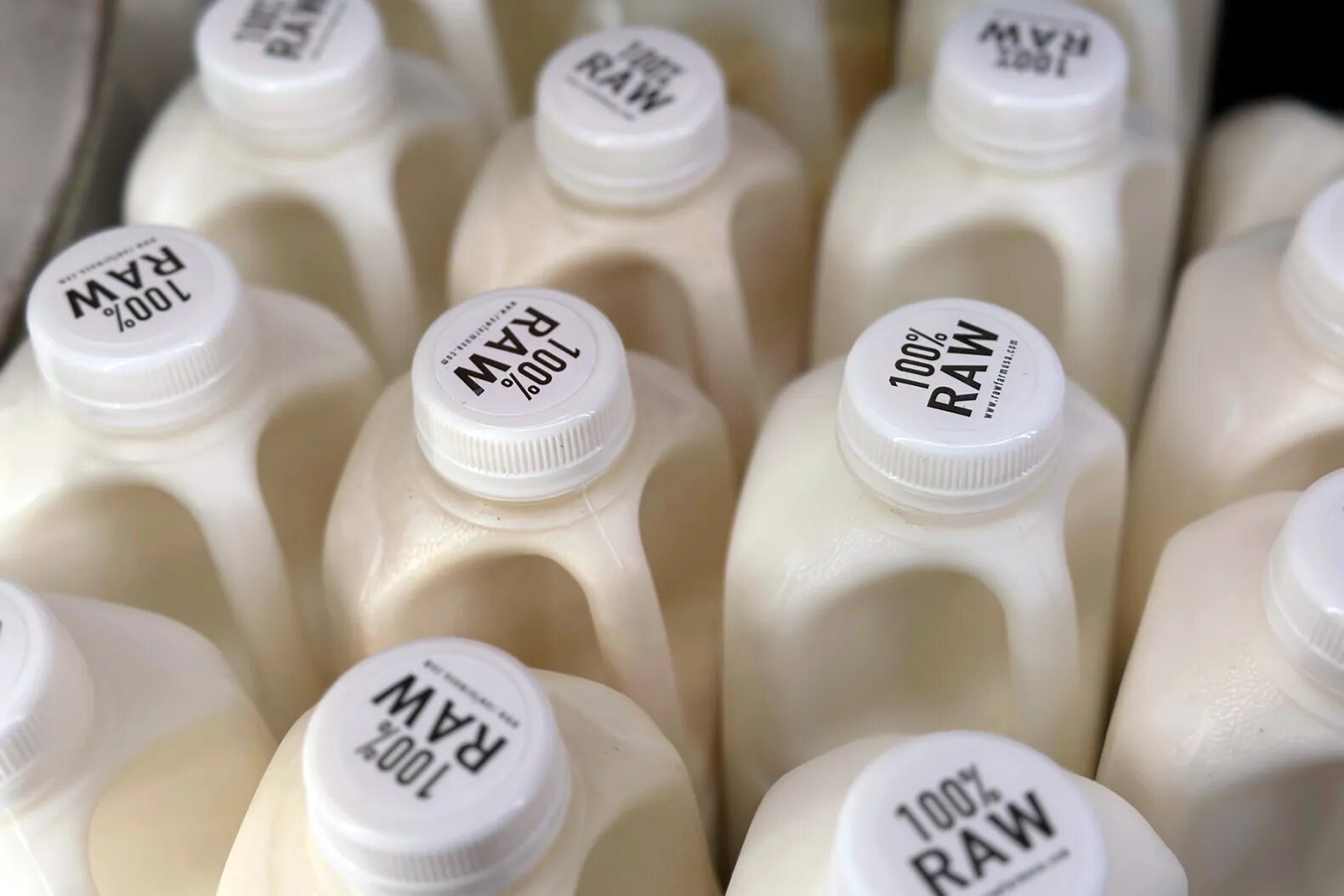 Bottles of raw milk are displayed for sale at a store in Temecula