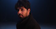 Armaan Malik in a black coat