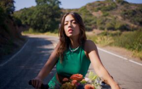 Bearnie wearing a red top on a bicylce on the road