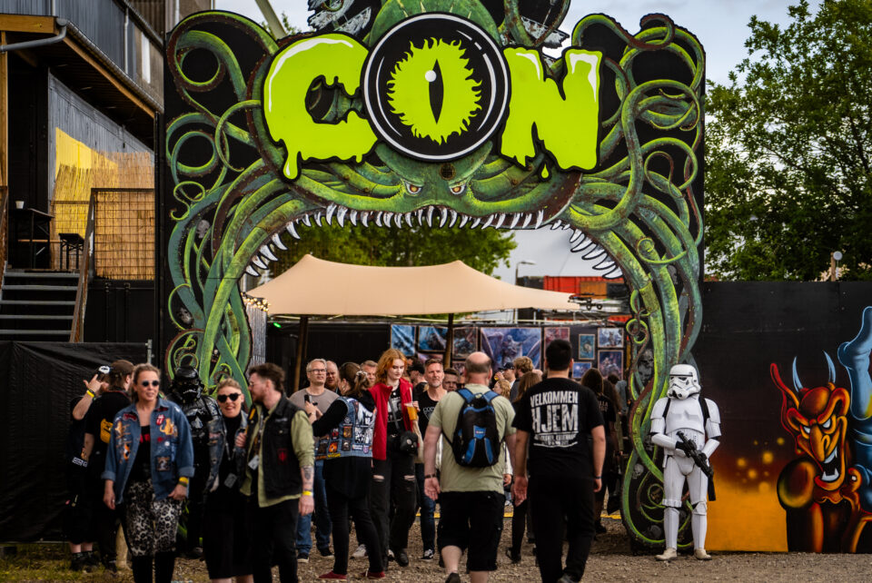 People walking through an archway at a metal festival