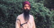 Sonny Singh wearing red turban and white jacket