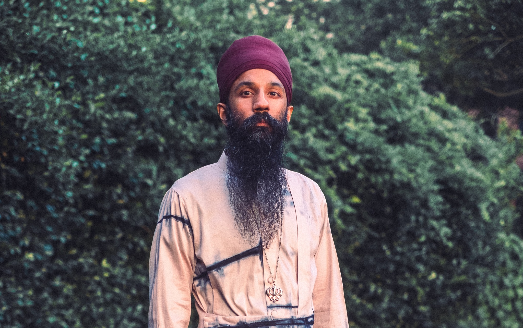 Sonny Singh wearing red turban and white jacket