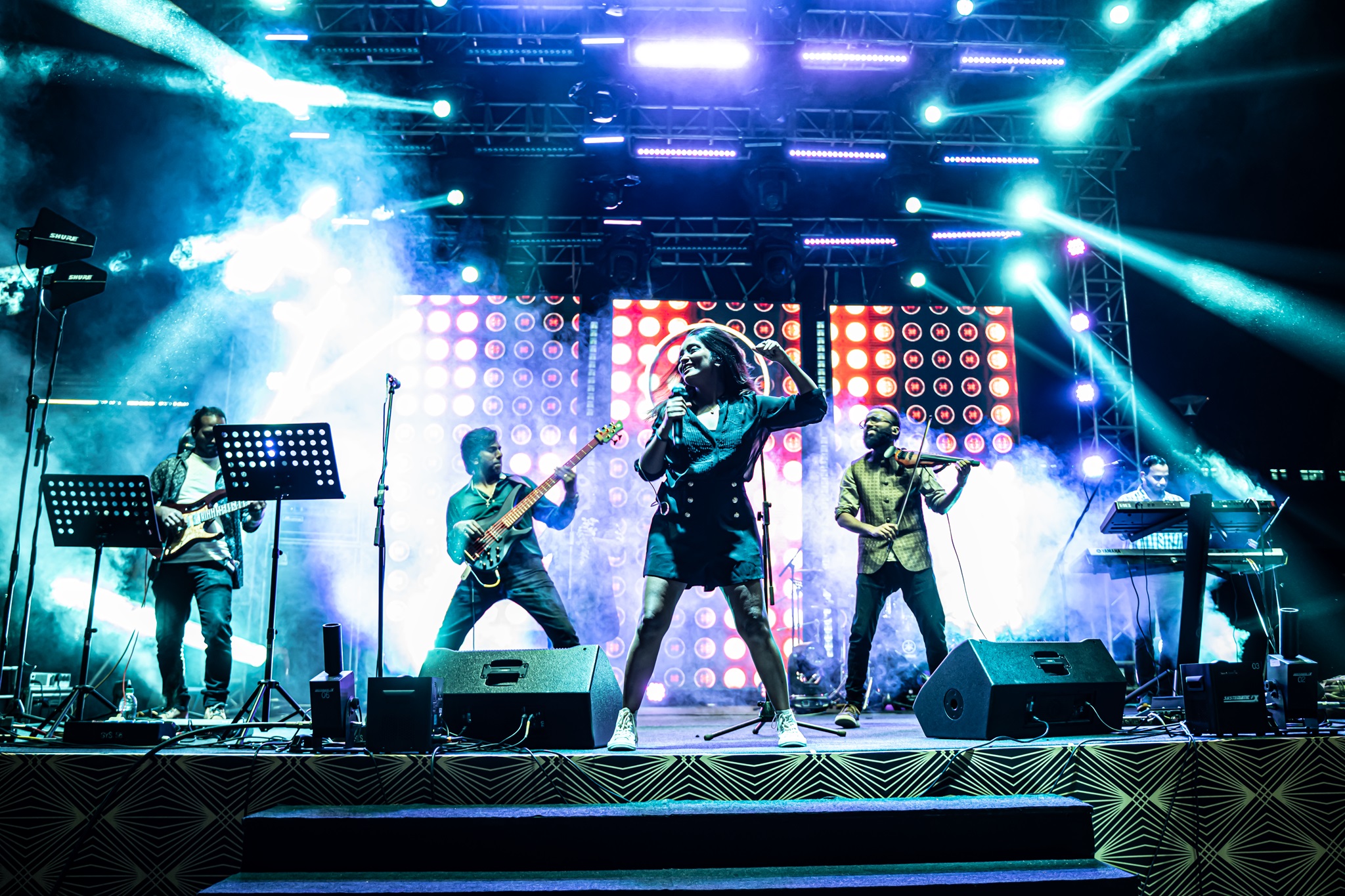 Zehen band members perfomring on stage at a concert