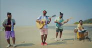 Folk Masti band members playing instruments on a beach