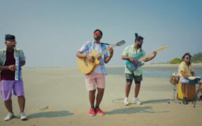 Folk Masti band members playing instruments on a beach