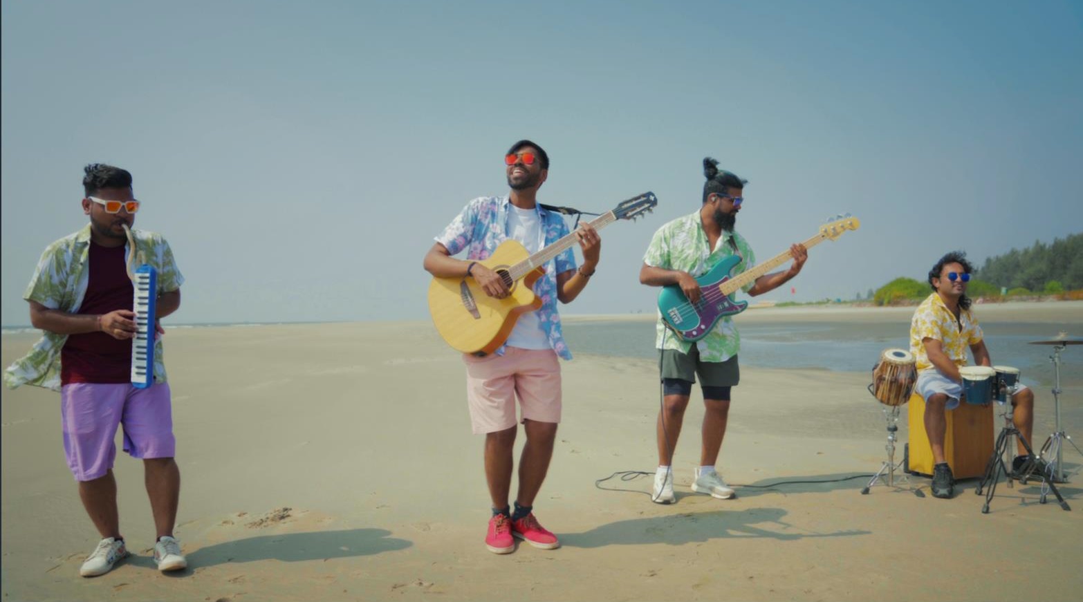 Folk Masti band members playing instruments on a beach