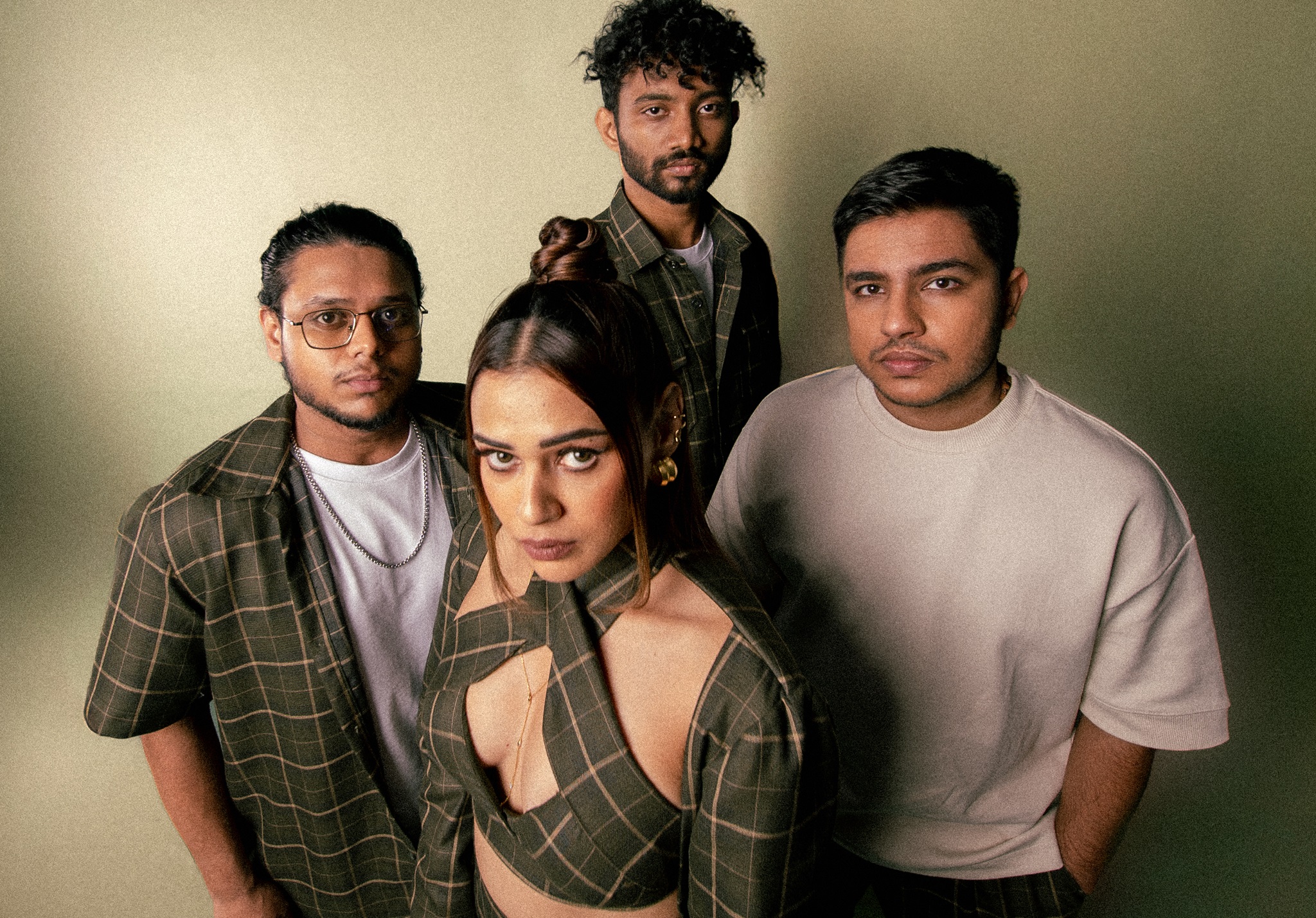 Shalmali Kholgade and her band wearing green and white posing for a photo