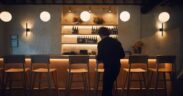 Chef Carmy walking into a table area of a restaurant in a still from the series 'The Bear'