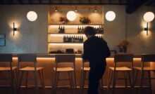 Chef Carmy walking into a table area of a restaurant in a still from the series 'The Bear'