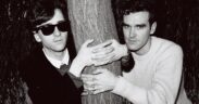 Johnny Marr and Morrissey of the group The Smiths posed with their arms around a tree trunk in London in 1983