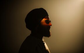 thiarajxtt wearing black turban and black sunglasses in silhouette