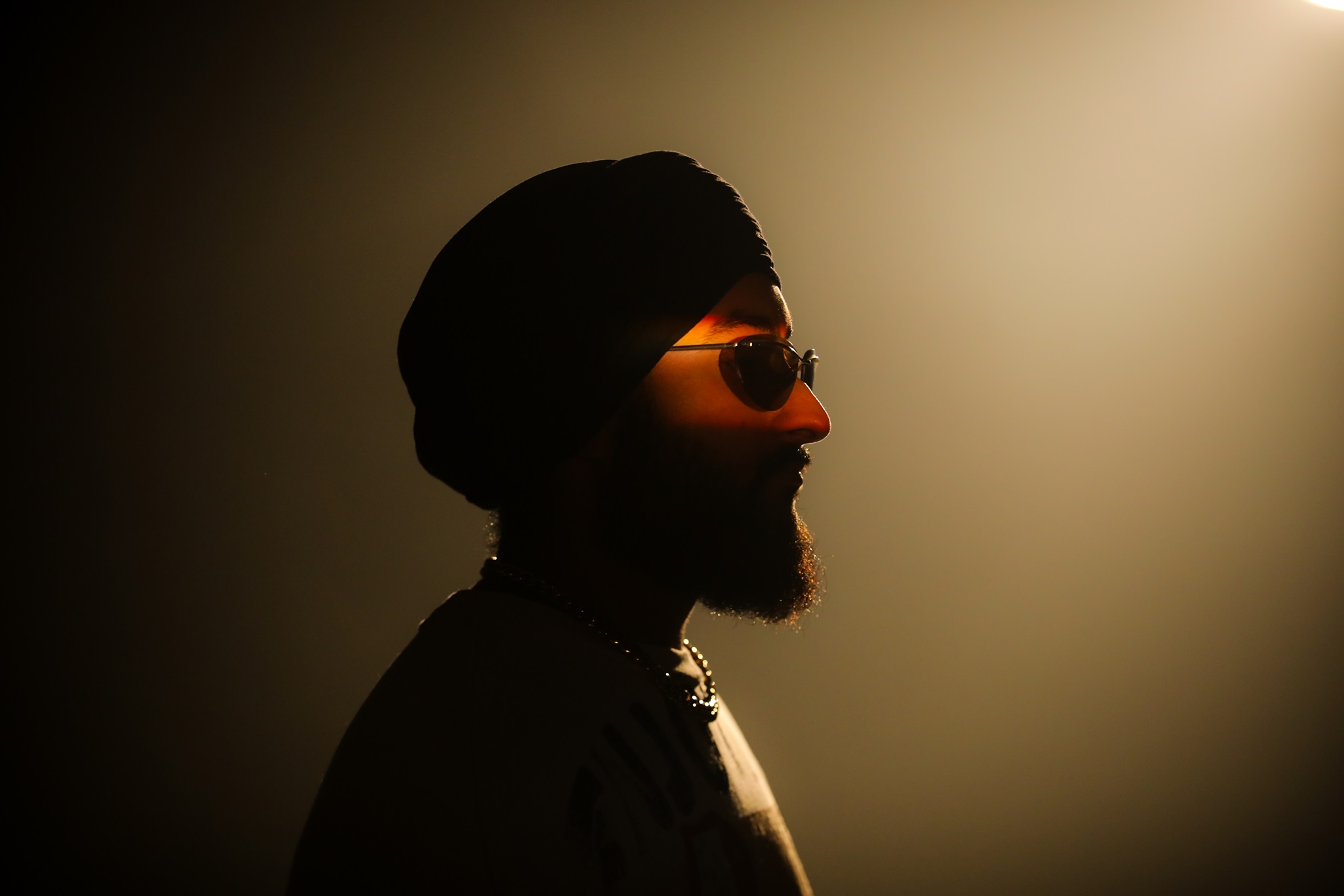 thiarajxtt wearing black turban and black sunglasses in silhouette