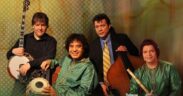 Musicians Bela Fleck with a mandolin, Zakir Hussain on tabla, Edgar Meyer on upright bass and Rakesh Chaurasia on flute