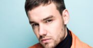 Liam Payne in an orange jacket and black turtleneck