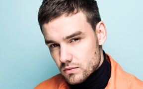 Liam Payne in an orange jacket and black turtleneck