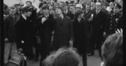 The Beatles departing from their plane to a sea of press in Disney's BEATLES '64