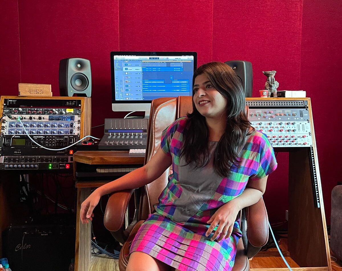 Pragnya Wakhlu seated at a recording studio console chair