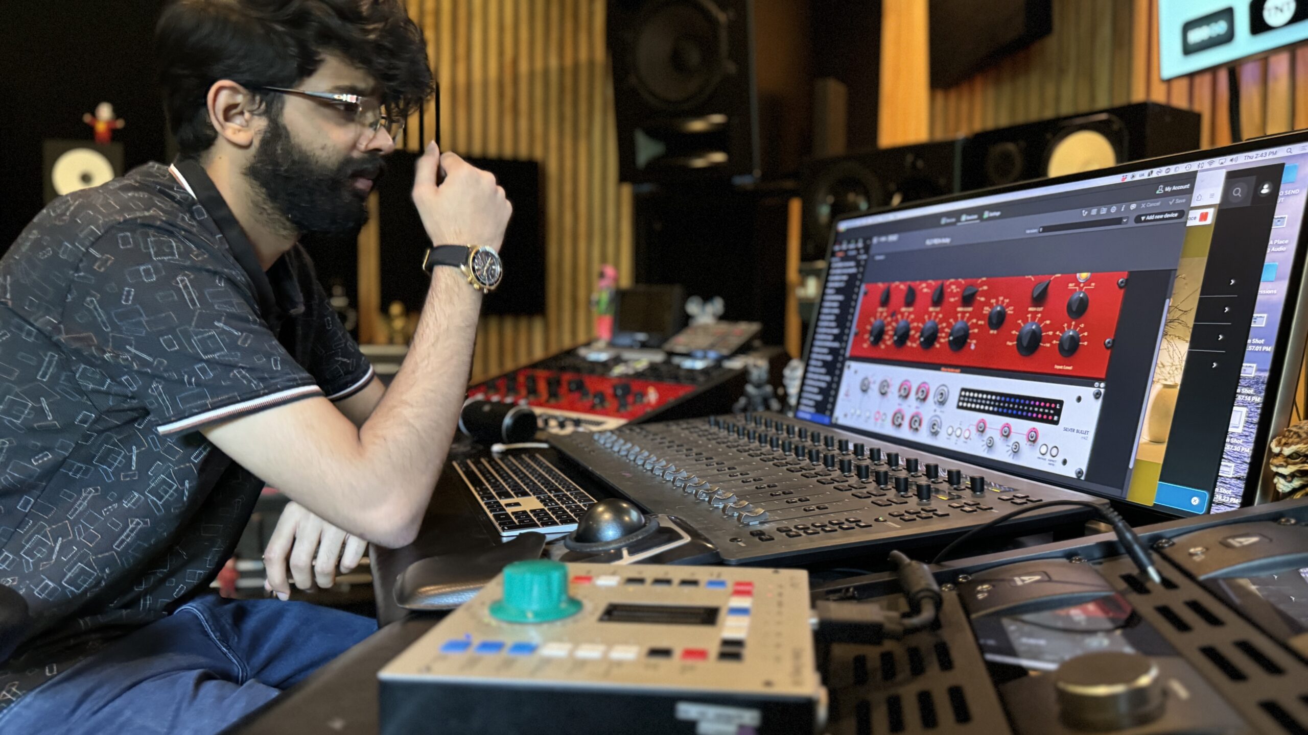 Sanjeevi Easwar in the studio looking at a sceen with a plugin