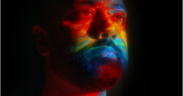 Spryk with a multicolor light projected on him