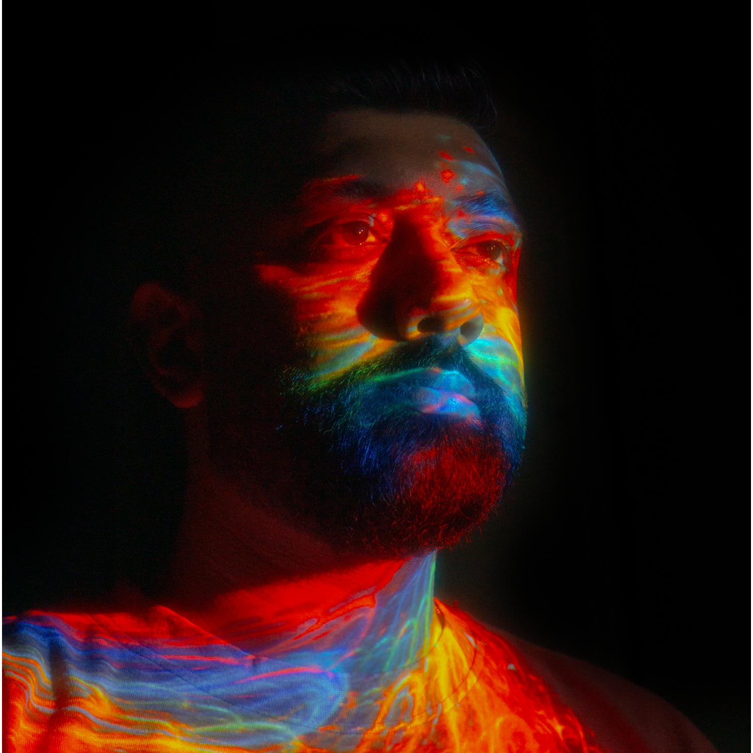 Spryk with a multicolor light projected on him