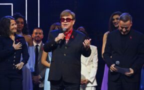 Elton John speaks on stage about losing eye sight.