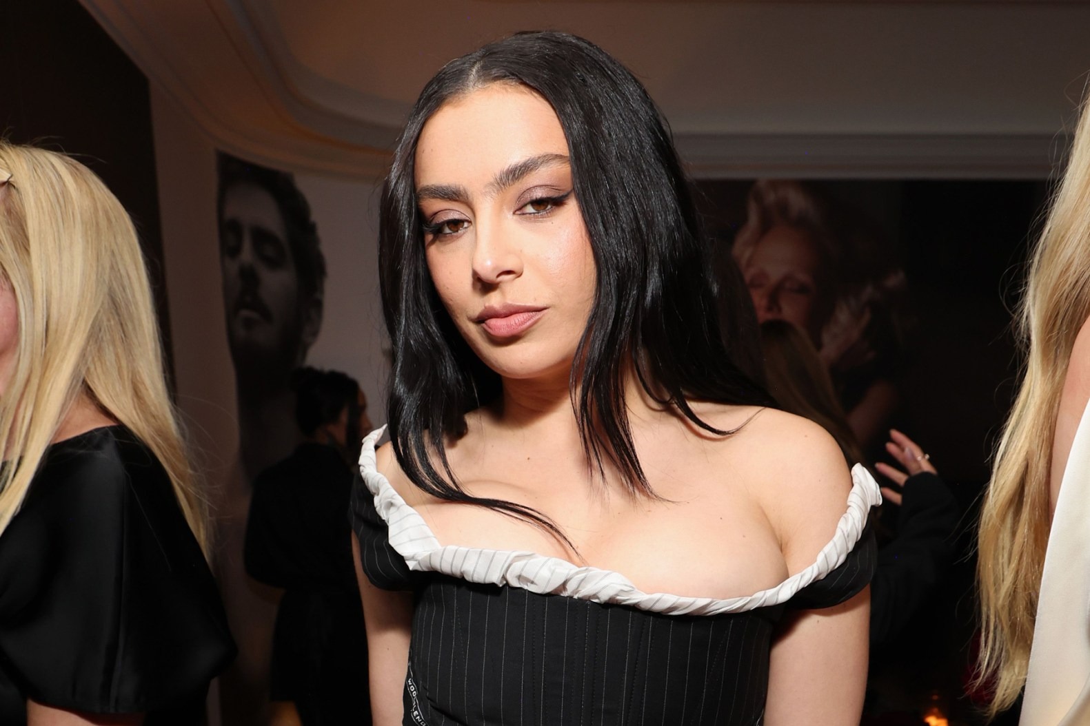 Charli XCX wearing a black dress