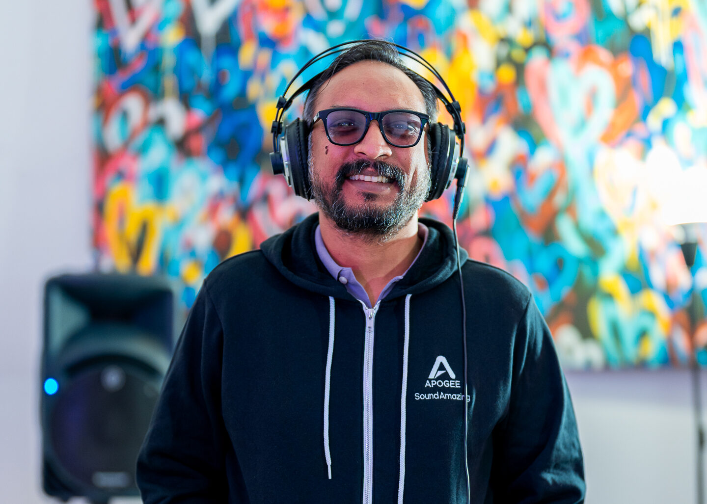 P.A. Deepak wearing black jacket, with headphones on