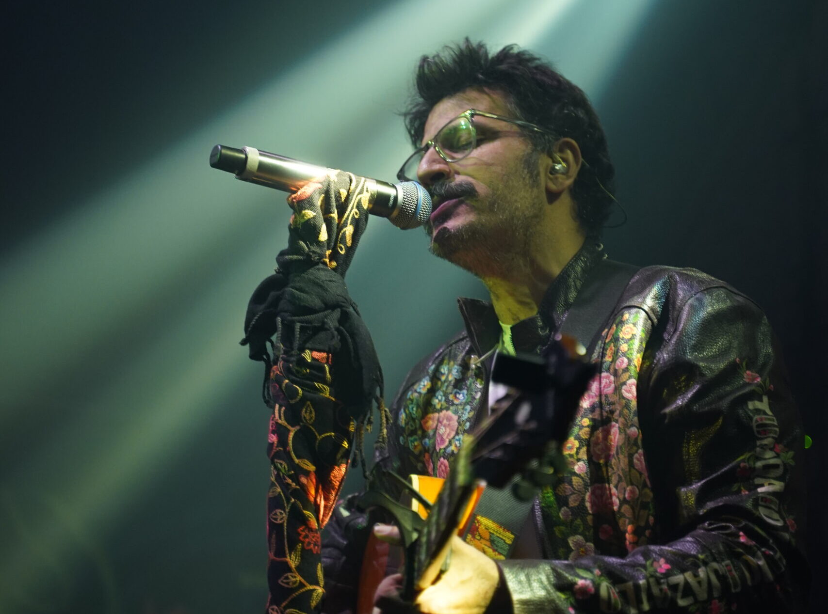 Kashmiri singer-songwriter Alif playing guitar and singing on stage