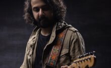 Guitarist Rohit Kulkarni wearing a jacket and playing guitar