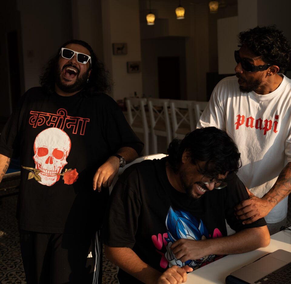 Shah Rule (standing, left) and Dino James (extreme right, standing) wearing Paapi merch