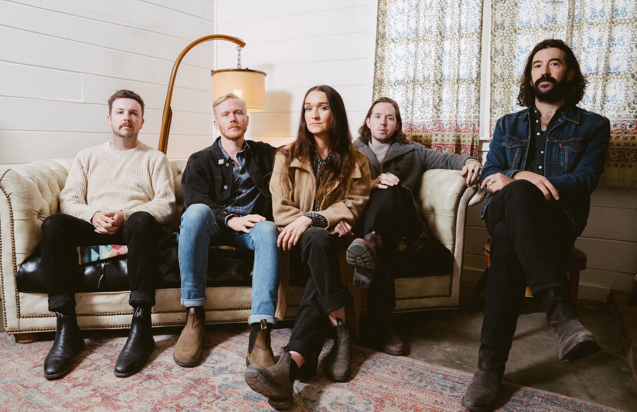 The Paper Kites band members sitting on a couch posing for a photo