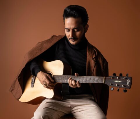 Tanishk Bagchi playing guitar