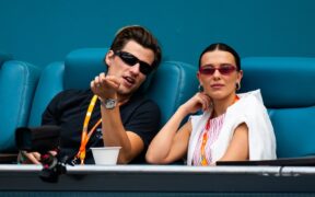 Jake Bongiovi and Millie Bobby Brown watch during the semi-final on Day 10 of the Miami Open at Hard Rock Stadium on March 27, 2025 in Miami Gardens, Florida